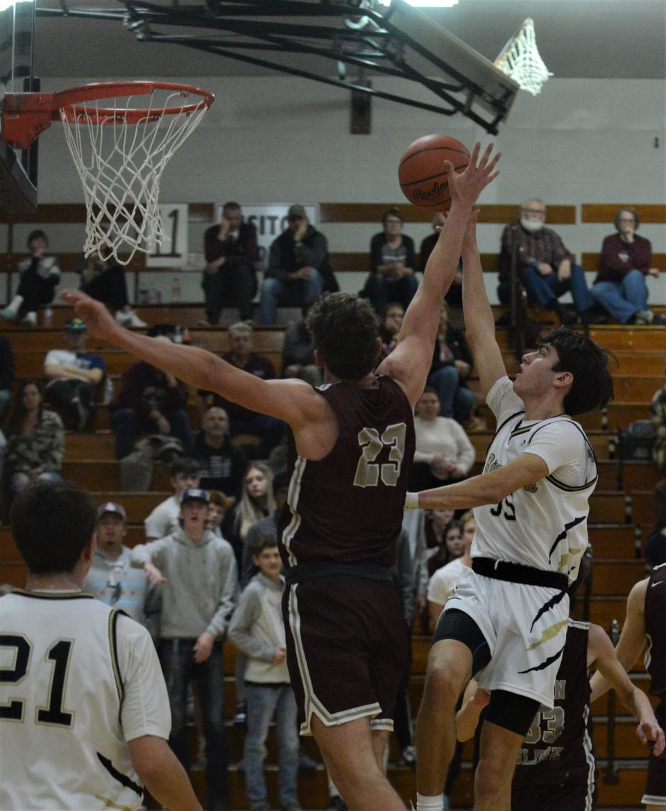 River View's Owen Emig shoots over John Glenn's Nathan Walker in Tuesday's MVL Big School clash. The Muskies won 77-62.