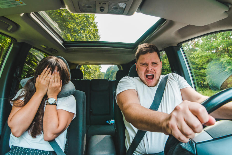 Couple driving in car; Man at the wheel, about to crash