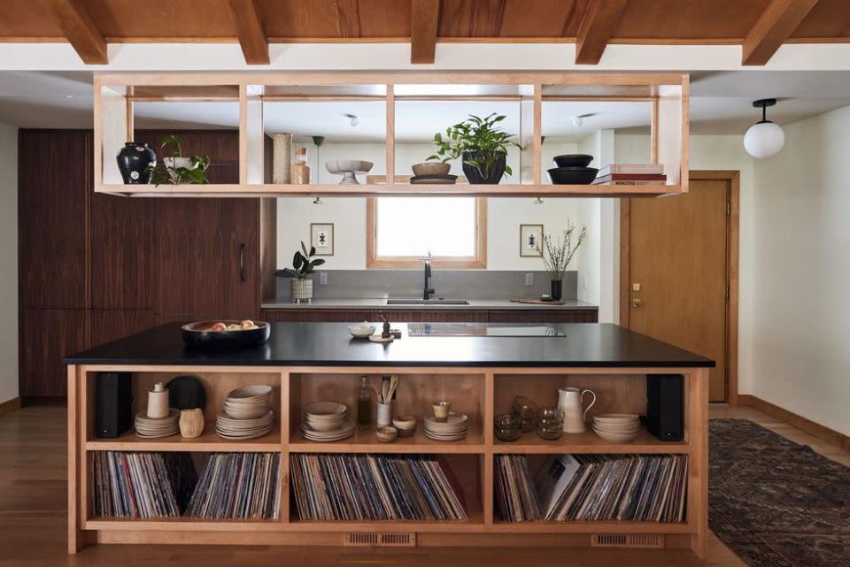 <p>During the heyday of MCM design, open or floating shelving was looked to as a way to separate an area of the home while maintaining open flow for increased entertaining and socializing. In <a href="https://www.housebeautiful.com/design-inspiration/home-makeovers/a40641143/prospect-refuge-studio-minnesota-kitchen-makeover/" rel="nofollow noopener" target="_blank" data-ylk="slk:this well-preserved midcentury rambler ranch" class="link ">this well-preserved midcentury rambler ranch</a>, designer Victoria Sass of <a href="https://prospectrefugestudio.com/" rel="nofollow noopener" target="_blank" data-ylk="slk:Prospect Refuge Studio" class="link ">Prospect Refuge Studio</a> leaned into the home's MCM roots with walnut perimeter cabinetry, vintage accessories, and an of-the-era floating shelf above the island. </p>