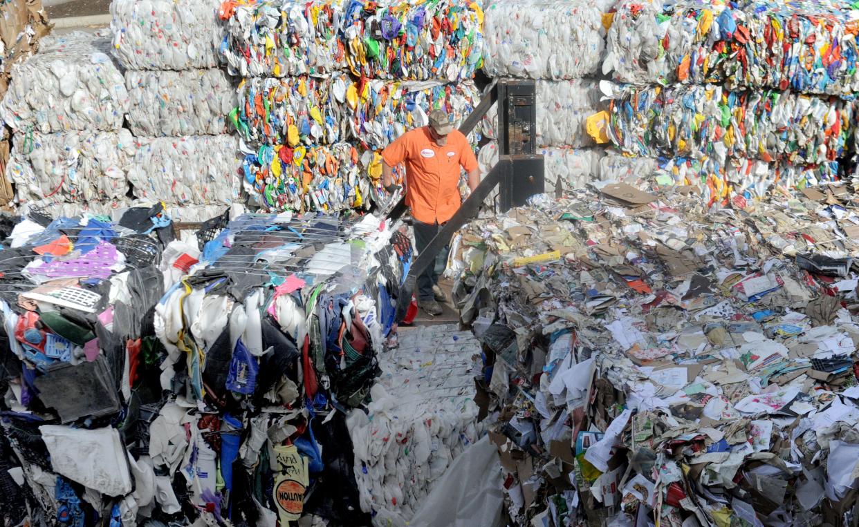 A worker at Gold Coast Recycling in Ventura loads up recyclable cardboard in 2019.