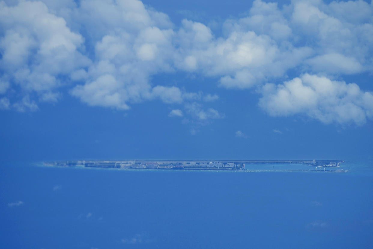 Chinese structures and buildings at the man-made island on Fiery Cross Reef at the Spratly group of islands in the South China Sea are seen on Sunday March 20, 2022. China has fully militarized at least three of several islands it built in the disputed South China Sea, arming them with anti-ship and anti-aircraft missile systems, laser and jamming equipment and fighter jets in an increasingly aggressive move that threatens all nations operating nearby, a top U.S. military commander said Sunday. (AP Photo/Aaron Favila)