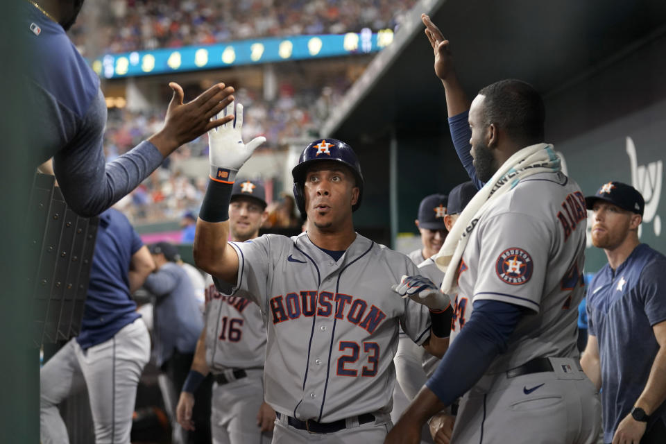 Houston Astros' Michael Brantley, center, celebrates with the team in the dugout after hitting a solo home run in the second inning of a baseball game against the Texas Rangers, Wednesday, Sept. 6, 2023, in Arlington, Texas. (AP Photo/Tony Gutierrez)