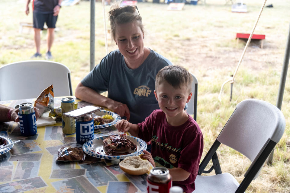 A young boy enjoys a plate of barbecue Saturday at the Homeless Heroes Bike Run event in Amarillo.