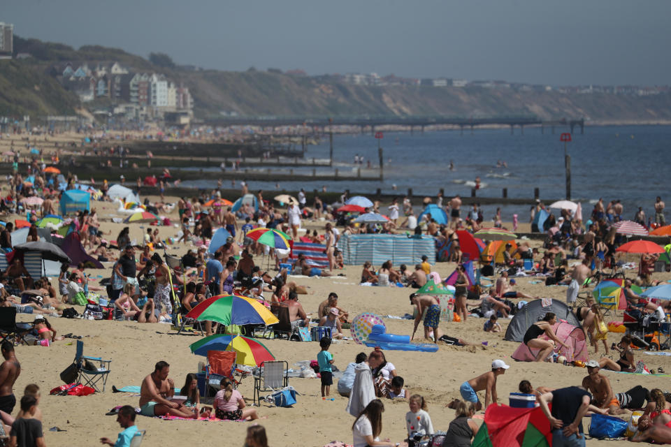 People enjoy the hot weather at Bournemouth beach in Dorset, as people flock to parks and beaches with lockdown measures eased. (Photo by Andrew Matthews/PA Images via Getty Images)