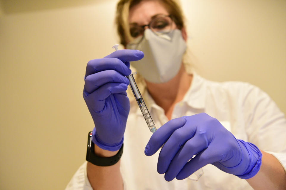 This Sept. 2020 photo provided by Johnson & Johnson shows a clinician preparing to administer investigational Janssen COVID-19 vaccine. Johnson & Johnson's long-awaited COVID-19 vaccine appears to protect against symptomatic illness with just one shot – not as strong as some two-shot rivals but still potentially helpful for a world in dire need of more doses. Johnson & Johnson said Friday, Jan. 29, 2021 that in the U.S. and seven other countries, the first single-shot vaccine appears 66% effective overall at preventing moderate to severe COVID-19. It was more protective against severe symptoms, 85%. (Johnson & Johnson via AP)