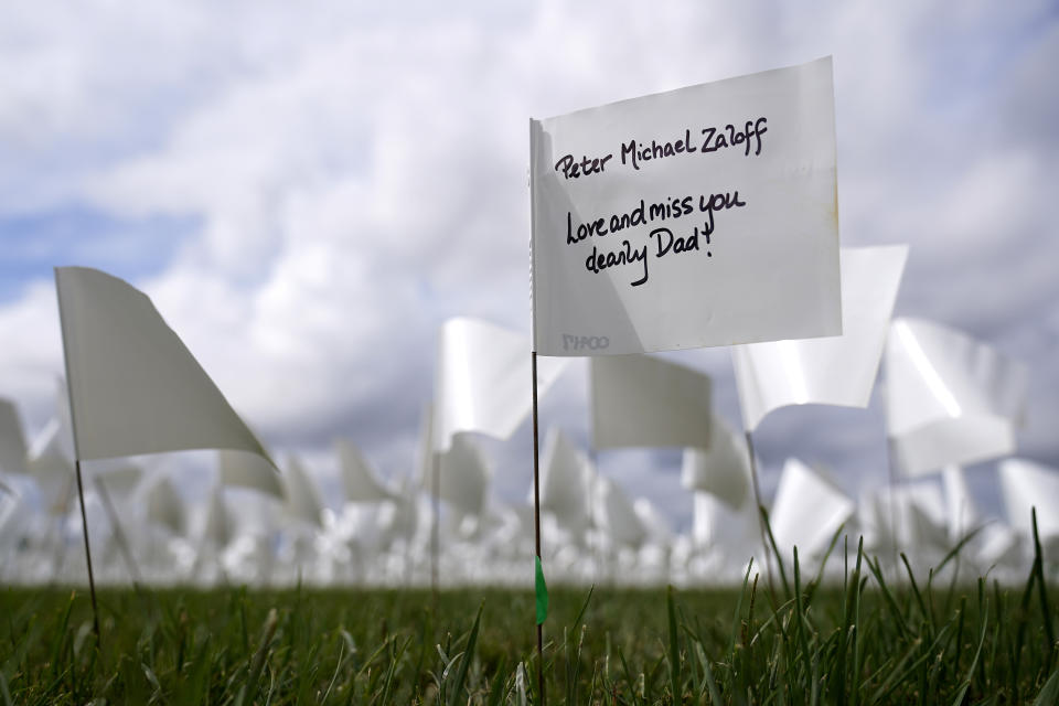 FILE - In this Sept. 21, 2021, file photo, message marks a white flag that is part of artist Suzanne Brennan Firstenberg's "In America: Remember," a temporary art installation to commemorate Americans who have died of COVID-19, on the National Mall in Washington. (AP Photo/Patrick Semansky, File)