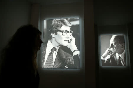 A visitor walks past photographs of Yves Saint Laurent and Pierre Berge at the Yves Saint Laurent Museum in Paris, France, September 27, 2017. REUTERS/Stephane Mahe