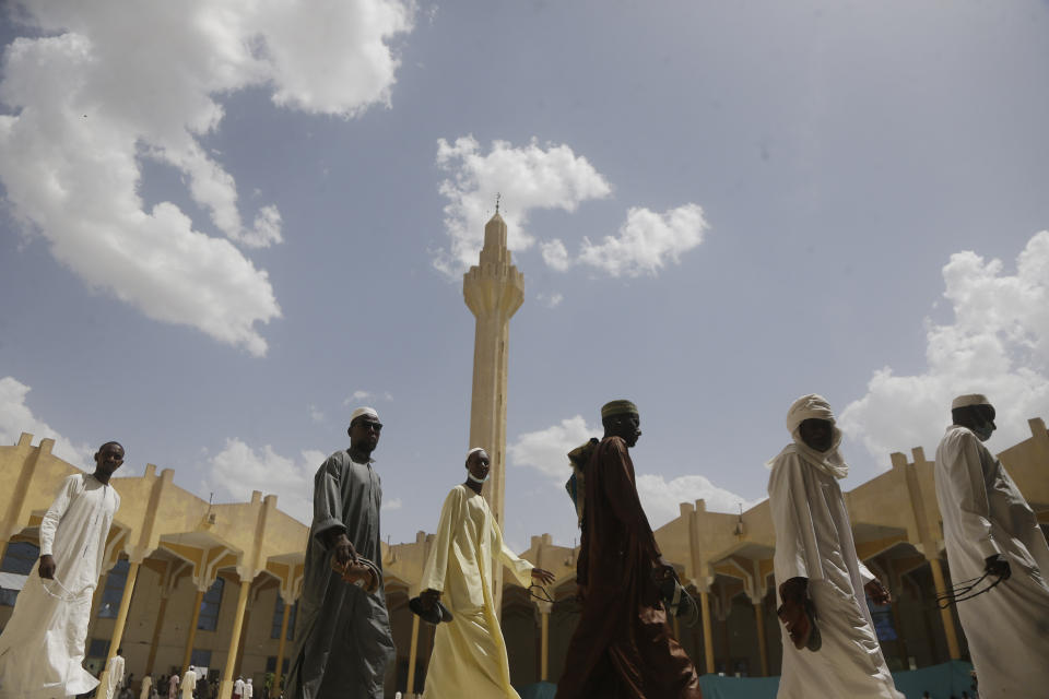 Muslims men leave after Friday prayers during the holy fasting month of Ramadan, at a Grand mosque in N'Djamena, Chad, Friday, April 30, 2021. (AP Photo/Sunday Alamba)