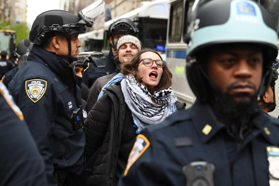 The demonstrators were led into one of several waiting police buses. Matthew McDermott