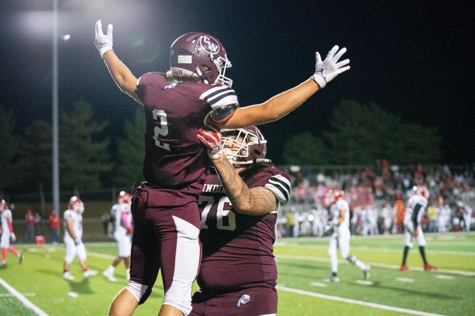 Canal Winchester's Matt Root (76) celebrates with Karson Martino after Martino scored a touchdown in a 35-14 win over visiting Westerville South on Friday.