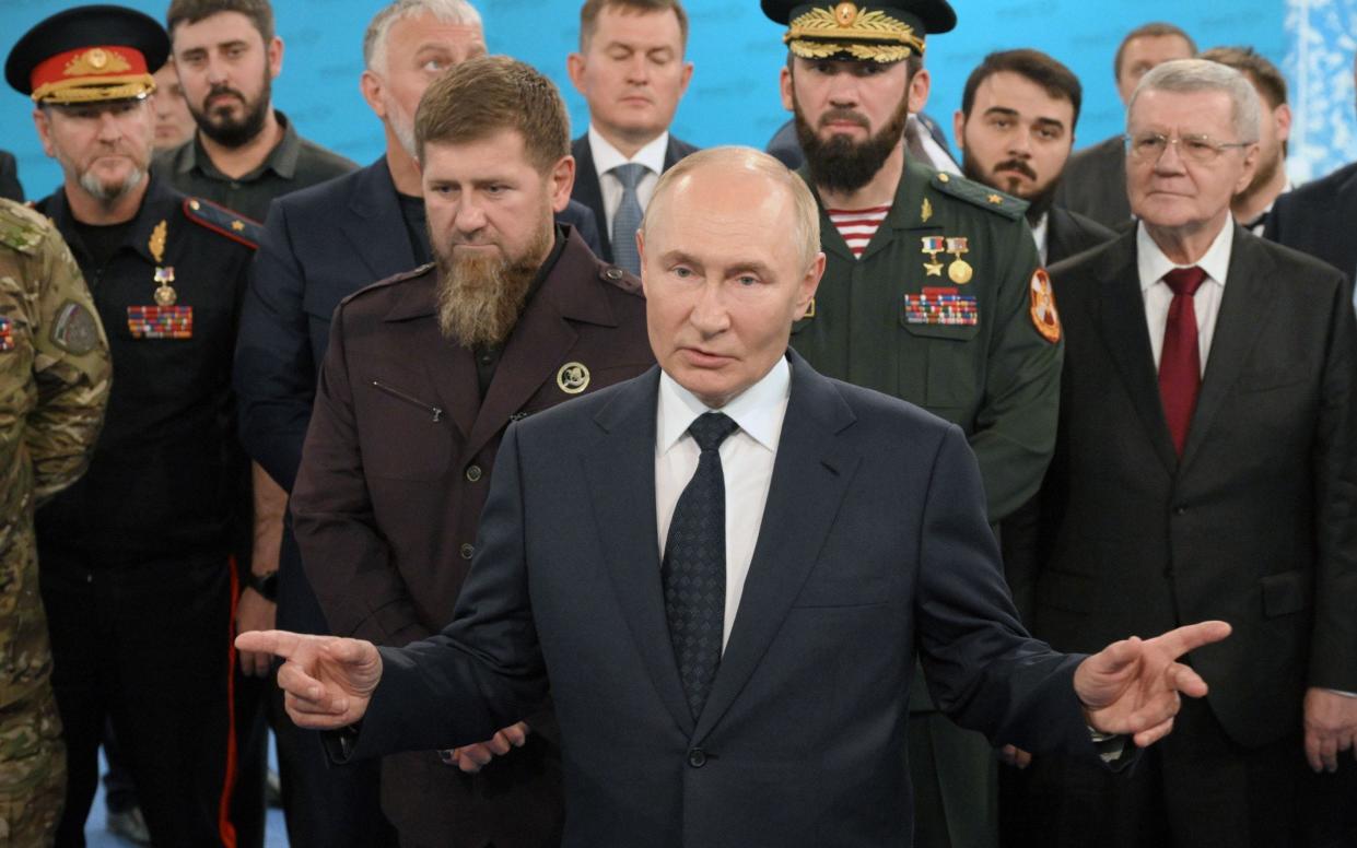 Russian President Vladimir Putin talks to troops during his visit to the Chechen Republic