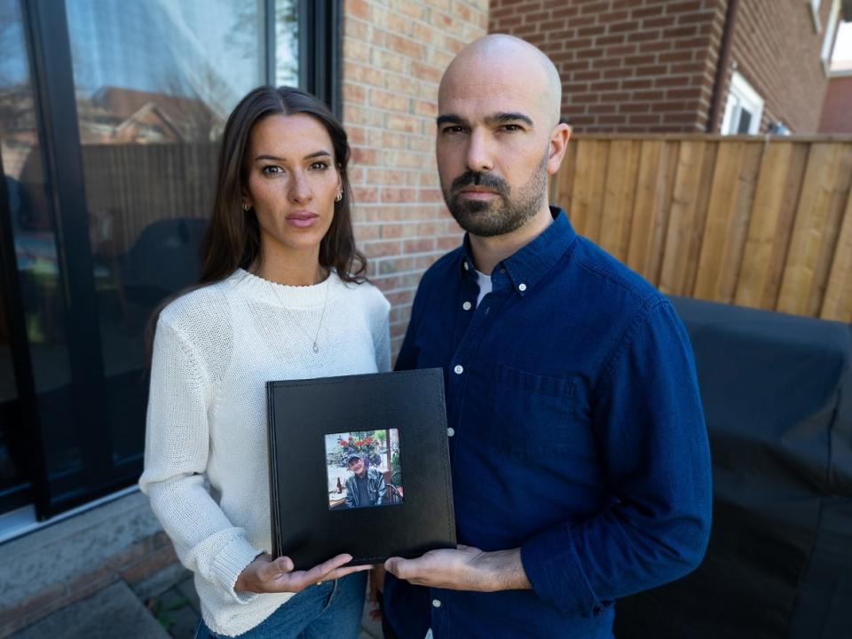 Christine and James Taylor hold a photo of their father, Douglas Taylor. They want police to take accountability for not notifying them of his death, even though police had their contact information.  (Paul Borkwood/CBC - image credit)