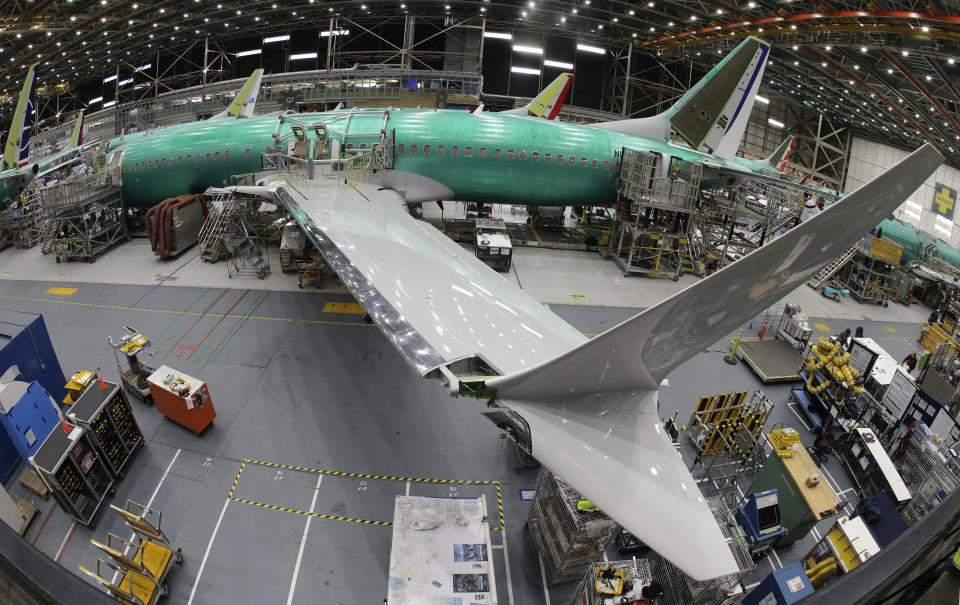 FILE - In this photo taken with a fish-eye lens, a Boeing 737 MAX 8 airplane sits on the assembly line during a brief media tour in Boeing's 737 assembly facility in Renton, Wash., March 27, 2019. Boeing is in talks to buy Spirit AeroSystems, which builds fuselages for Boeing 737 Max jetliners including the one that suffered a door-panel blowout in January, according to a published report, Friday, March 1, 2024. (AP Photo/Ted S. Warren, File)