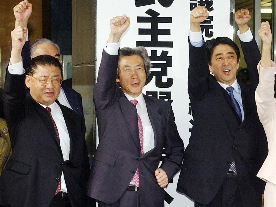Shinzo Abe (right) with the then Japanese prime minister Junichiro Koizumi (centre) and vice-president Taku Yamazaki (left) in 2003 (AFP/Getty)
