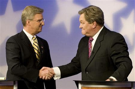 Challenger Bryan Smith (L) and incumbent Congressman Mike Simpson (R-ID) shake hands as they meet for a televised debate for the upcoming Republican primary election at the studios of Idaho Public Television in Boise, Idaho May 11, 2014. REUTERS/Patrick Sweeney