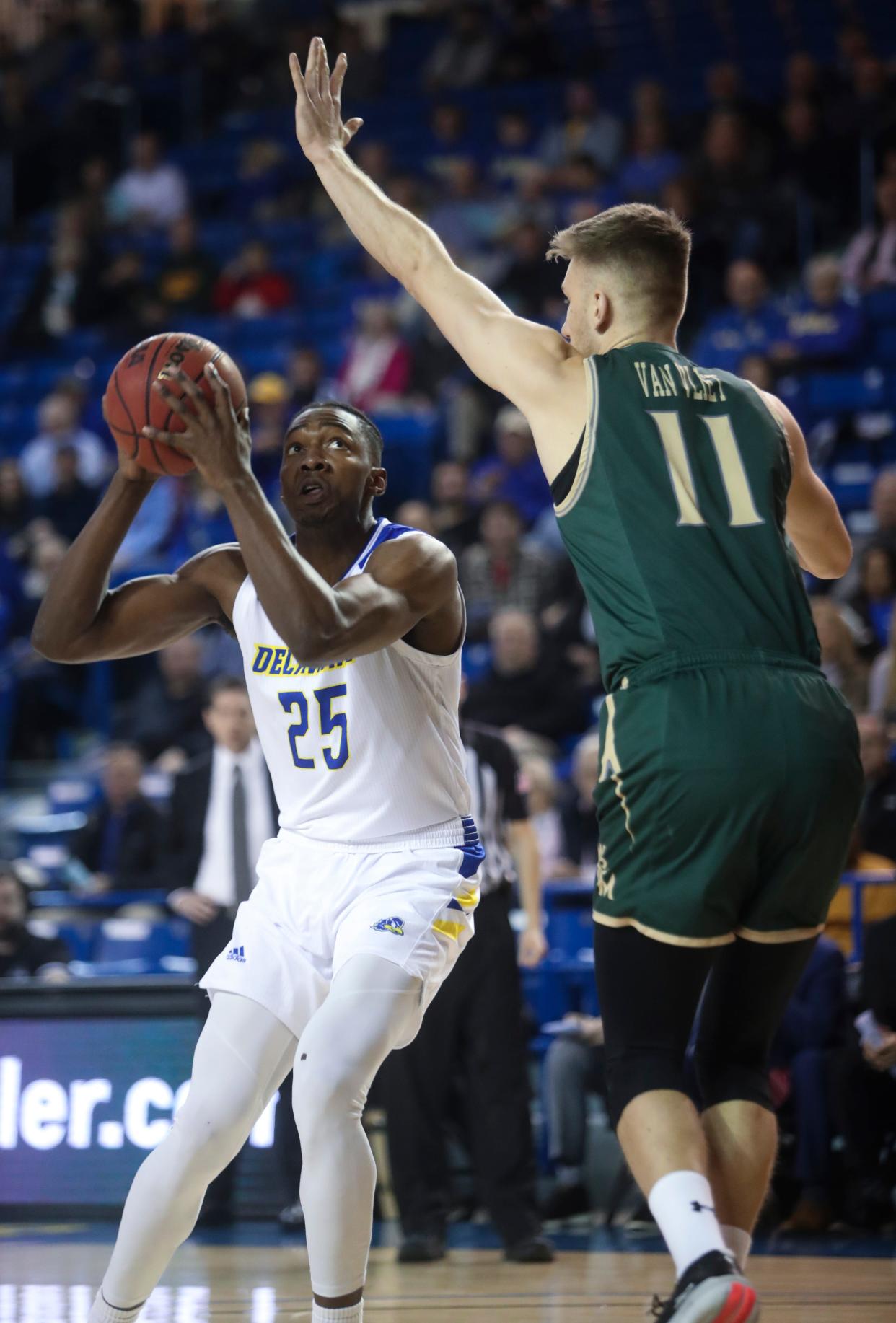 Delaware forward Justyn Mutts looks past William and Mary's Andy Van Vliet in the first half of Delaware's 77-68 loss at the Bob Carpenter Center Thursday.