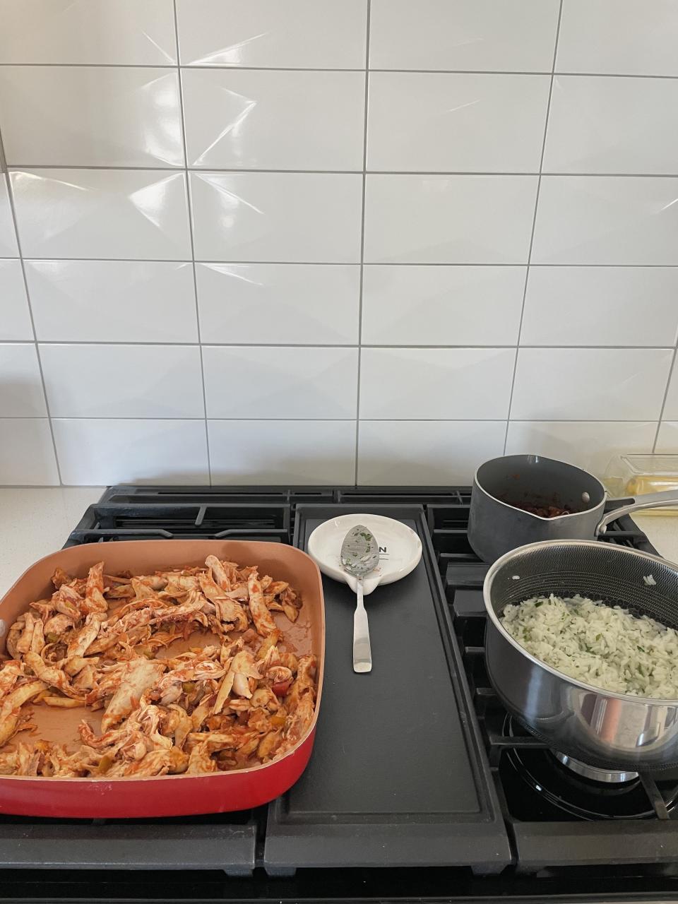 chicken, beans, and rice on the stove