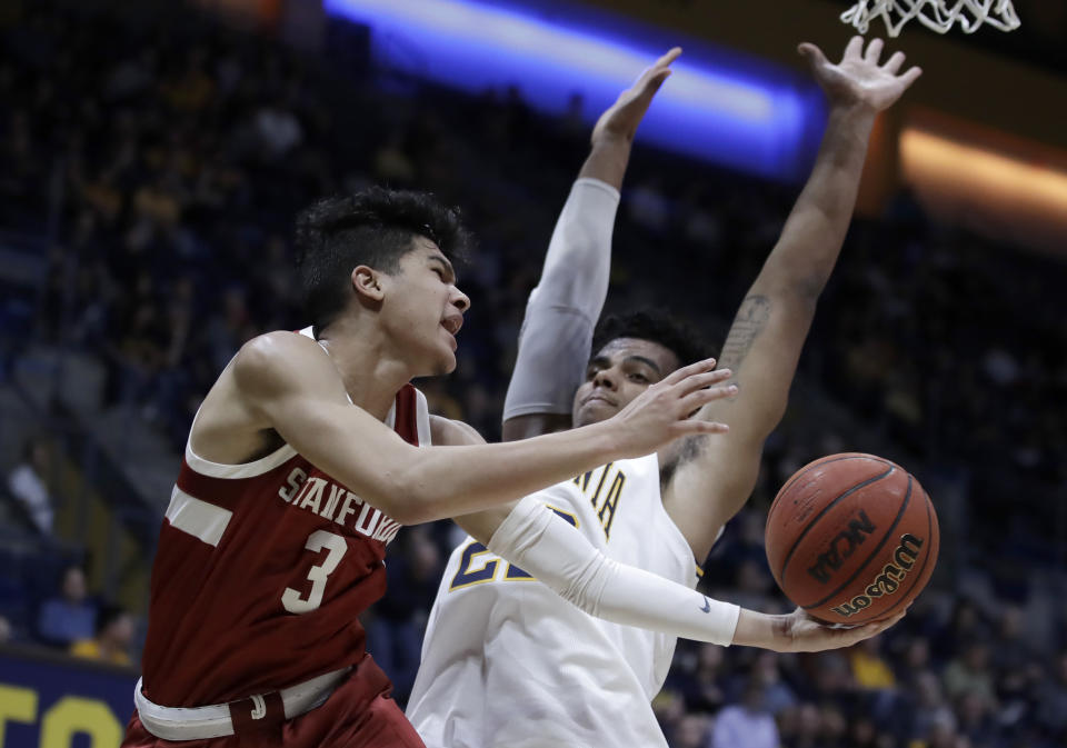 Stanford's Tyrell Terry (3) passes the ball away from California's Andre Kelly in the first half of an NCAA college basketball game Sunday, Jan. 26, 2020, in Berkeley, Calif. (AP Photo/Ben Margot)