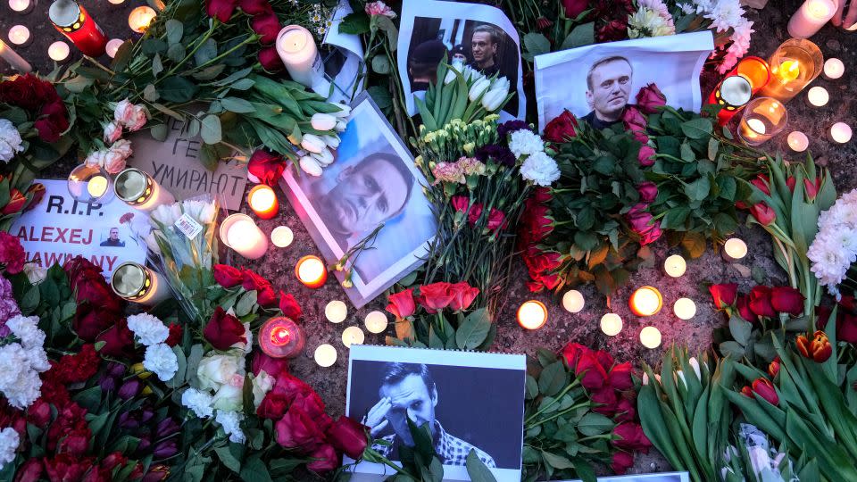 Flowers and candles were laid in a memorial for Navalny in front of the Russian embassy in Berlin, Germany, February 16, 2024. - Ebrahim Noroozi/AP