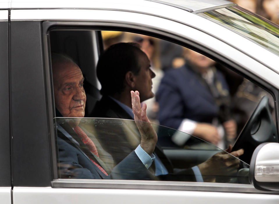 Spain's King Juan Carlos, left, waves his hand during his departure from San Jose hospital where he received medical treatment in Madrid, Spain, Wednesday, April 18, 2012. Spain's King Juan Carlos says he is sorry for having gone on African elephant-hunting trip. In an unprecedented gesture, the 74-year-old monarch said he was "very sorry. I made a mistake. It won't happen again." The king came under scathing criticism this week after he went on a safari trip to Botswana as Spain writhes in its one of its worst ever economic crises. The trip came to light when the king ended up having to be taken to hospital for hip treatment after having fallen. (AP Photo/Andres Kudacki)