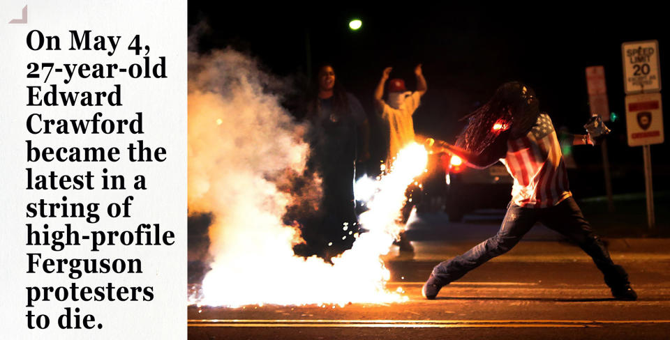 Edward Crawford returns a tear gas container shot by tactical police officers in Ferguson. (Photo: Robert Cohen/St. Louis Post-Dispatch via ZUMA Press)