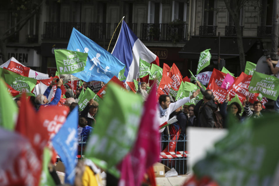 Conservative activists gather to protest in Paris, Sunday Oct. 6, 2019, against a French bill that would give lesbian couples and single women access to in vitro fertilization and related procedures. Traditional Catholic groups and far-right activists organized Sunday's protest, arguing that it deprives children of the right to a father. (AP Photo/Rafael Yaghobzadeh)