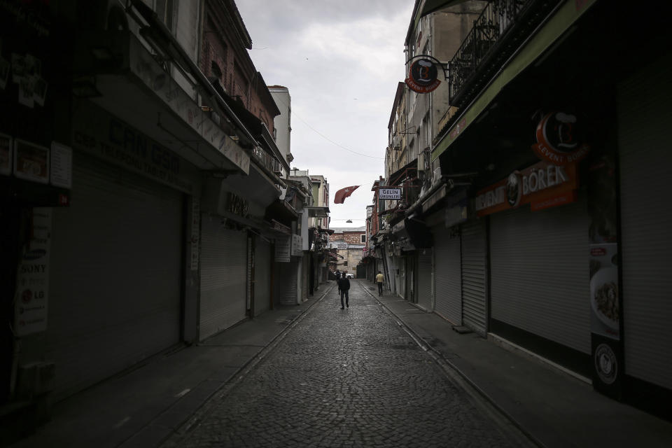 People walk in Eminonu market, an area usually packed with shop goers, but currently nearly deserted due to the strict lockdown to help curb the spread of the coronavirus, in Istanbul, Saturday, May 8, 2021. The "full lockdown," which began in late April and will last until May 17 came amid a huge surge in infections. (AP Photo/Emrah Gurel)