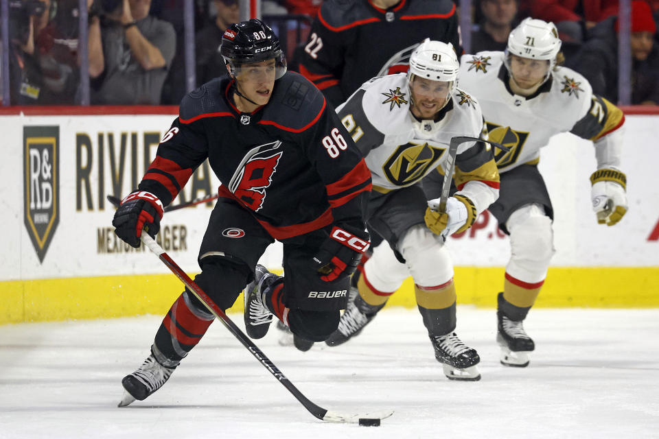 Carolina Hurricanes' Teuvo Teravainen (86) moves the puck up the ice after taking it from Vegas Golden Knights' Jonathan Marchessault (81) during the second period of an NHL hockey game in Raleigh, N.C., Tuesday, Dec. 19, 2023. (AP Photo/Karl B DeBlaker)