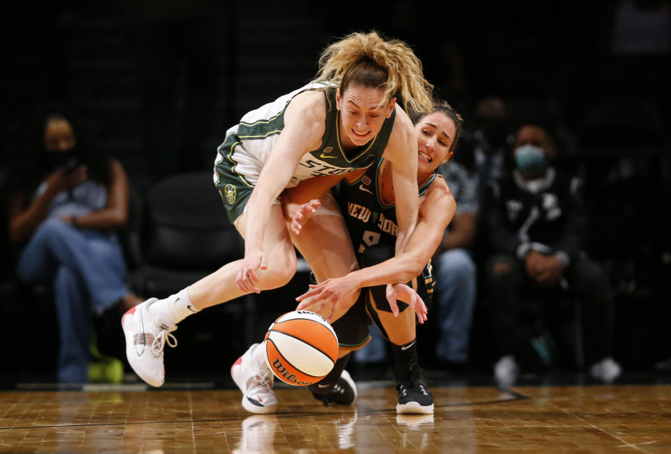 Seattle Storm's Breanna Stewart, left, and New York Liberty's Rebecca Allen, right, go after a loose ball during the first half of a WNBA basketball game Friday, Aug. 20, 2021, in New York. (AP Photo/Noah K. Murray)