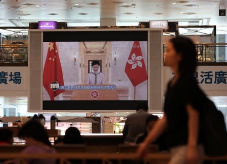 Hong Kong Chief Executive Carrie Lam delivers her third policy address via TV after her session at the legislative council was disrupted by heckling pro-democracy lawmakers, as seen at a shopping mall in Hong Kong