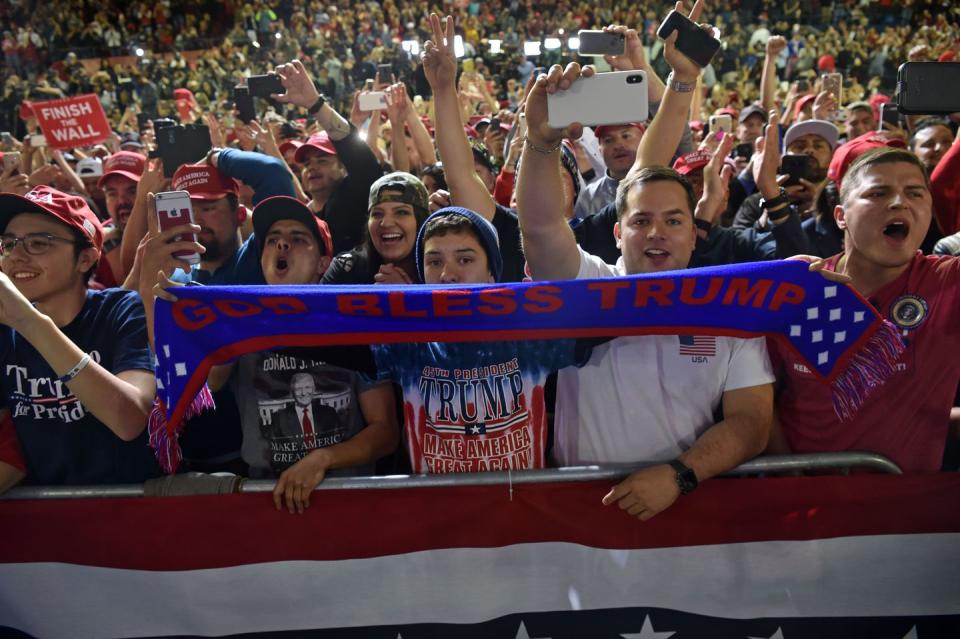 <p>Supporters of Donald Trump hold a sign that says, "God Bless Trump," during a rally in El Paso. </p>