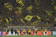 Dortmund supporters wave flags after the Champions League semifinal first leg soccer match between Borussia Dortmund and Paris Saint-Germain at the Signal-Iduna Park stadium in Dortmund, Germany, Wednesday, May 1, 2024. Dortmund won 1-0. (AP Photo/Matthias Schrader)