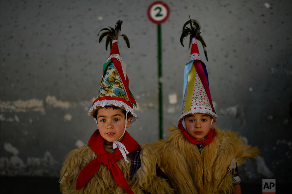 <p>Two young Joaldunaks called Zanpantzar, take part in the Carnival between the Pyrenees villages of Ituren and Zubieta, northern Spain. In one of the most ancient carnivals in Europe, dating from before the Roman empire, companies of Joaldunak (cowbells) made up of residents of two towns, Ituren and Zubieta, parade the streets costumed in sandals, lace petticoats, sheepskins around the waist and shoulders, coloured neckerchiefs, conical caps with ribbons and a hyssop of horsehair in their right hands and cowbells hung across their lower back. (AP Photo/Alvaro Barrientos) </p>