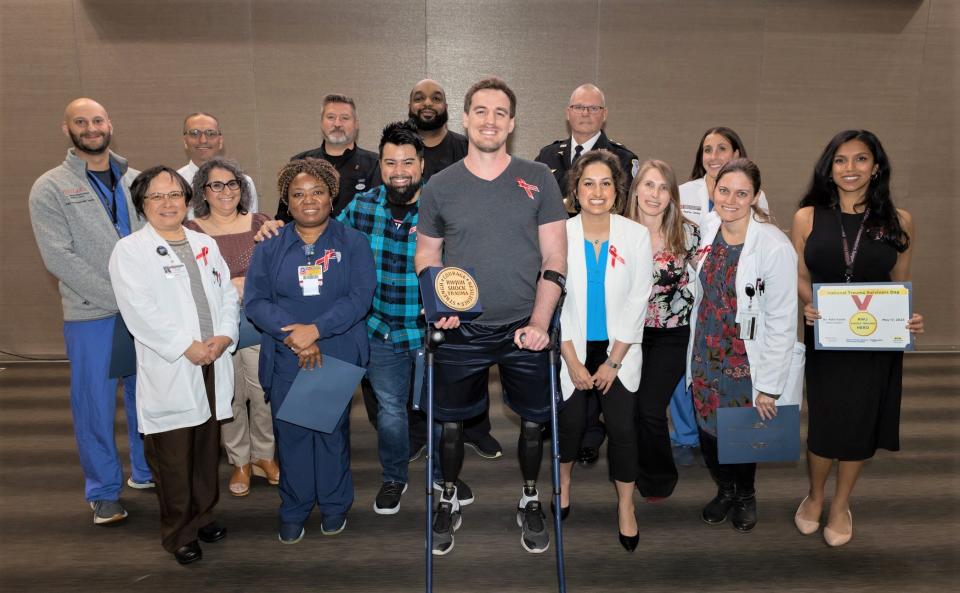 John Esposito with members of the Robert Wood Johnson University Hospital and Rutgers Robert Wood Johnson Medical School's Shock Trauma Program, who helped care for him following a cash in which he lost his legs.