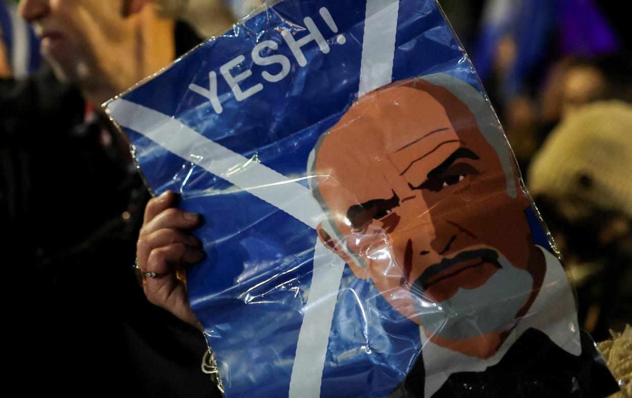 A person holds a placard depicting Scottish actor Sean Connery during a pro-Independence rally outside the Scottish Parliament in Edinburgh - Russell Cheyne/REUTERS