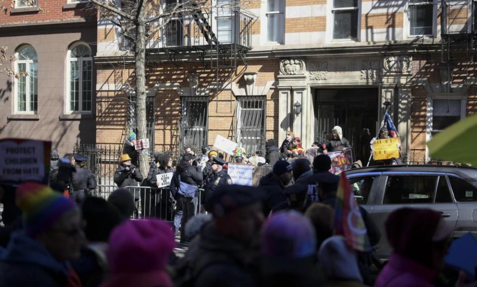 A group of protesters gather outside a Manhattan drag story hour as counter-protesters lined the sidewalk to show their support for the event, on 19 March.
