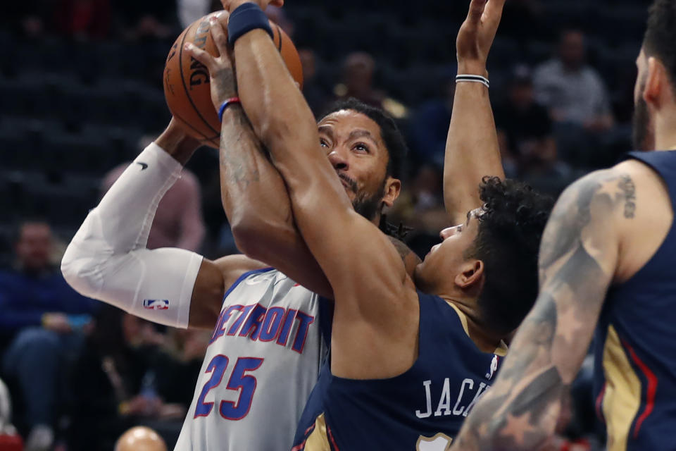 New Orleans Pelicans guard Frank Jackson (15) reaches in on Detroit Pistons guard Derrick Rose (25) during the first half of an NBA basketball game, Monday, Jan. 13, 2020, in Detroit. (AP Photo/Carlos Osorio)