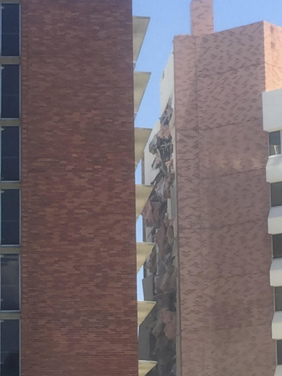 The aftermath of an explosion inside a residence hall at the University of Nevada, Reno in Reno, Nev., is visible on Friday, July 5, 2019. Police referred to the incident as a "utilities accident." There were no immediate reports of injuries. (Raymond Floyd via The AP)