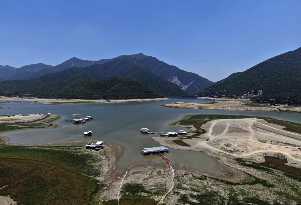 A view of The Boca reservoir that supplies water to the northern city of Monterrey is almost dry as the northern part of Mexico is affected by an intense drought, in Santiago, Mexico, Saturday, July 9, 2022. Local authorities began restricting water supplies in March, as a combination of an intense drought, poor planning and high use has left the three dams that help supply the city dried up, with thousands of homes not receiving any water for weeks. (AP Photo/Fernando Llano)