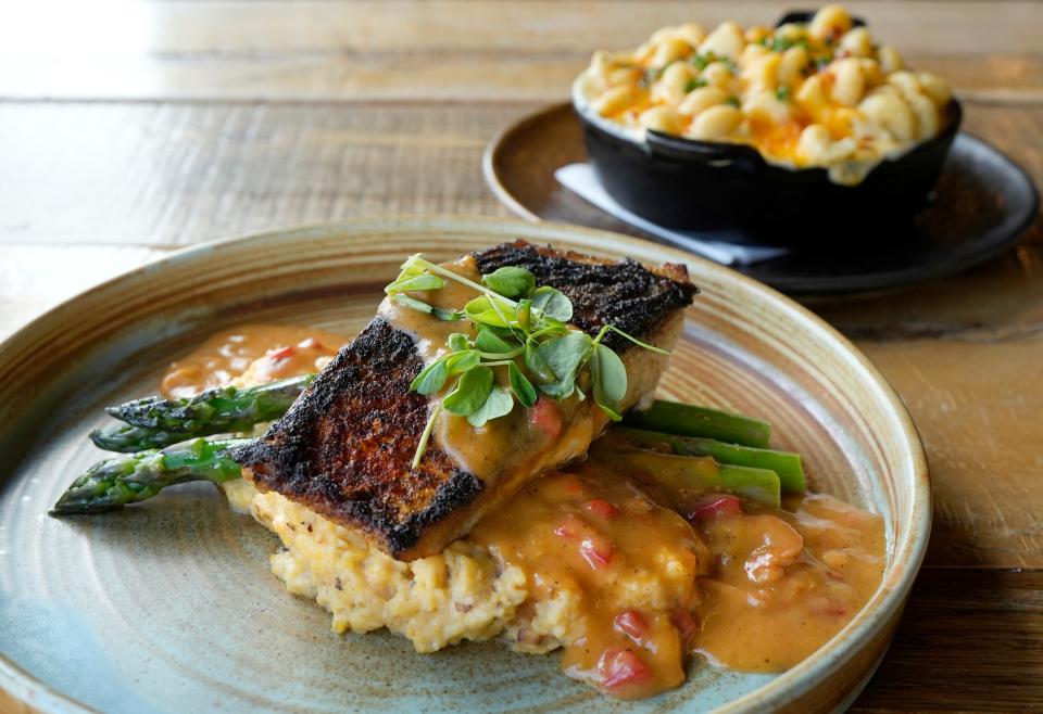 Subourbon specializes in Southern cooking such as this blackened redfish served with shrimp etouffee, cheesy grits and charred asparagus, and accompanied by a side of macaroni and cheese.