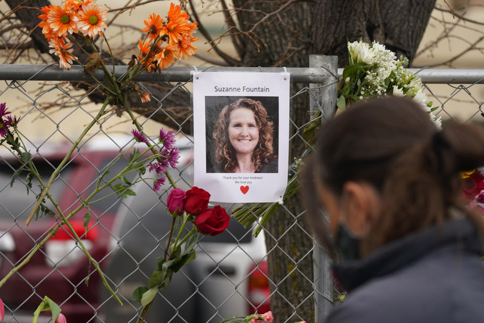 A photograph of Suzanne Fountain, one of the victims of a mass shooting at a King Soopers grocery store, hangs on the temporary fence around the store Wednesday, March 24, 2021, in Boulder, Colo. (AP Photo/David Zalubowski)