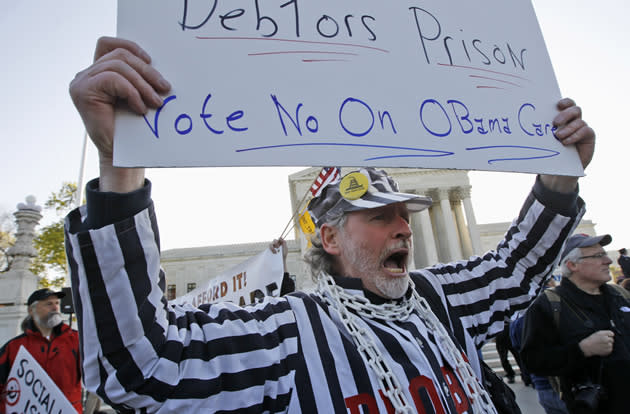 Michael Wade, from East Brookfield, Mass., who opposes health care reform, rallies in front of the Supreme Court.