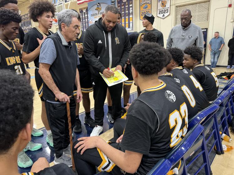 King/Drew coach Lloyd Webster directs his team during a timeout on Tuesday against Marina.