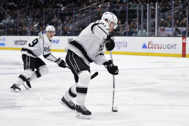 Los Angeles Kings right wing Carl Grundstrom (91) shoots for a goal against the Seattle Kraken during the third period of an NHL hockey game Saturday, April 1, 2023, in Seattle. (AP Photo/John Froschauer)