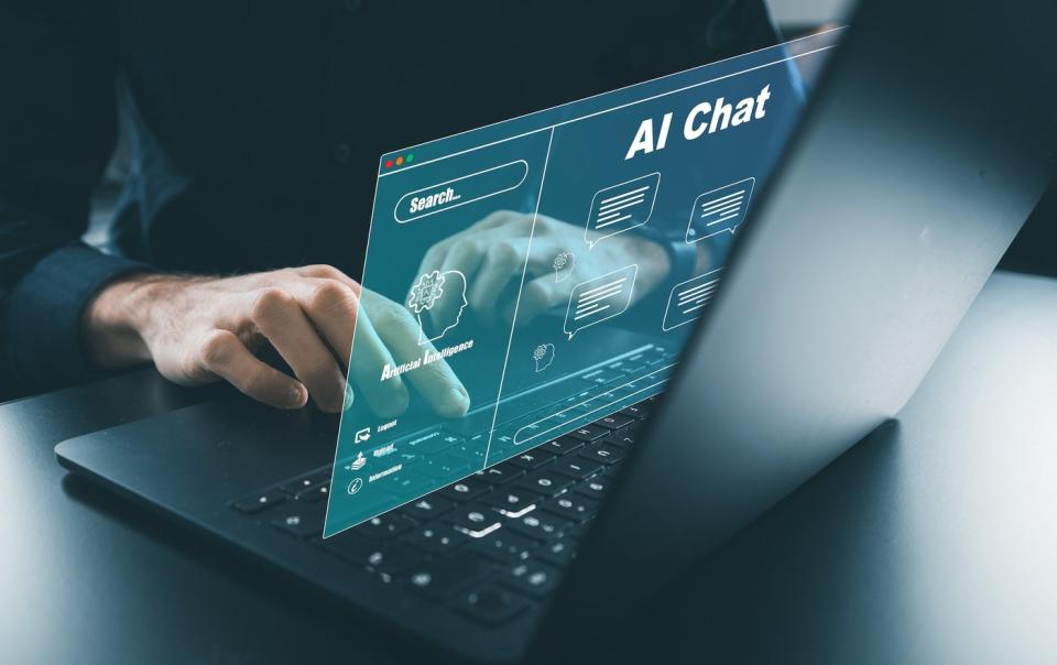 A person using a computer whose graphic says AI chat.