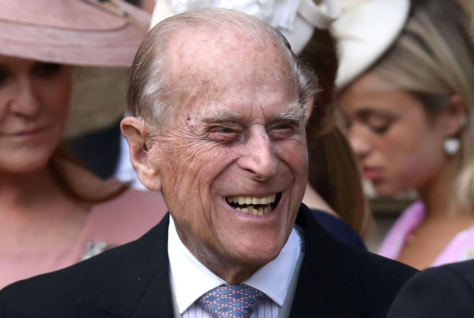 Britain's Prince Philip, Duke of Edinburgh reacts as he talks with Britain's Prince Harry, Duke of Sussex as they leave St George's Chapel in Windsor Castle, Windsor, west of London, on May 18, 2019, after the wedding of Lady Gabriella Windsor and Thomas Kingston.