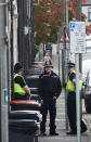 Police officers stand outside a house being searched after three men were arrested in connection with an explosion on the London Underground, in Newport, Wales, Britain, September 20, 2017. REUTERS/Rebecca Naden