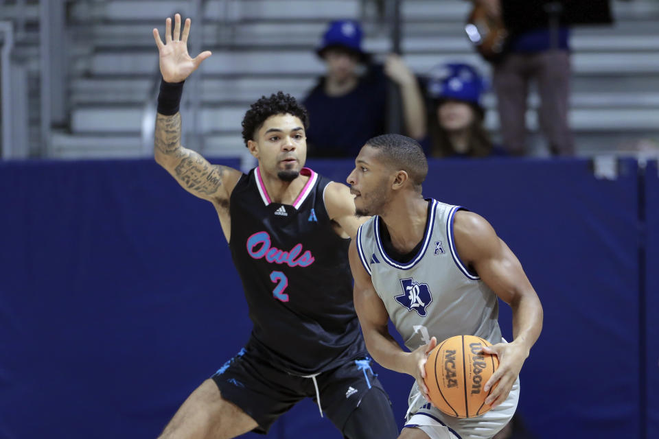 Rice guard Travis Evee, right, looks to pass the ball under pressure from Rice guard Mekhi Mason (2) during the first half of an NCAA college basketball game Wednesday, Jan. 24, 2024, in Houston. (AP Photo/Michael Wyke)