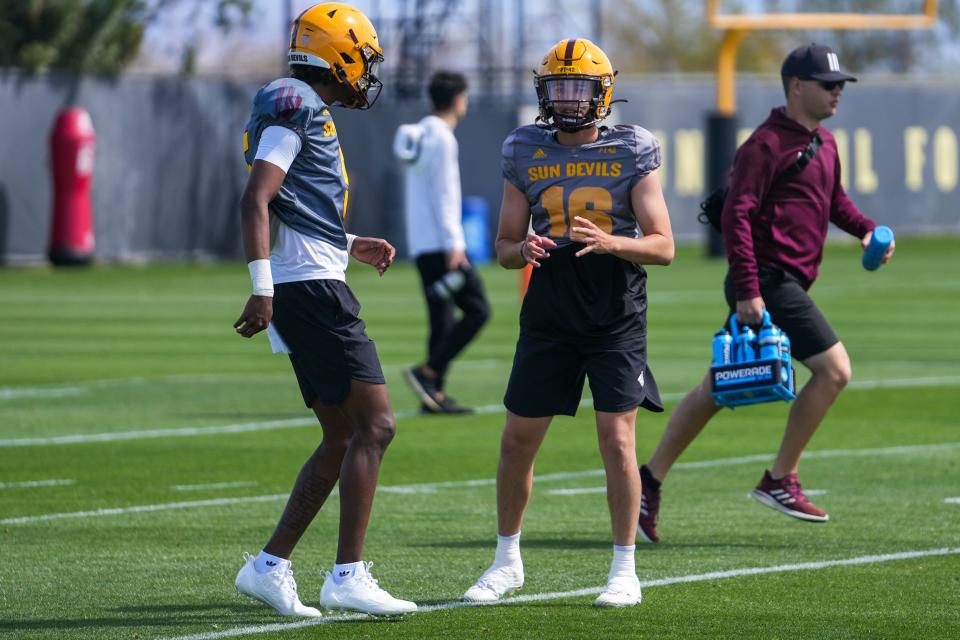 Sun Devils quarterback Jaden Rashada (left) and quarterback Trenton Bourguet (16) talk between drills during an ASU football practice at Kajikawa Football Practice Fields on Saturday, March 18, 2023, in Tempe.