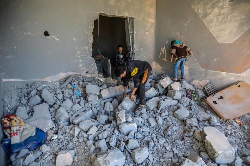 Palestinian citizens inspect the effects of the destruction caused by air strikes on their homes on Nov. 29, 2023, in Khan Yunis, Gaza.